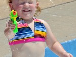 Reagan Burghart, 2, tests out a water gun at the Kendall Memorial pool.