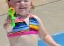 Reagan Burghart, 2, tests out a water gun at the Kendall Memorial pool.